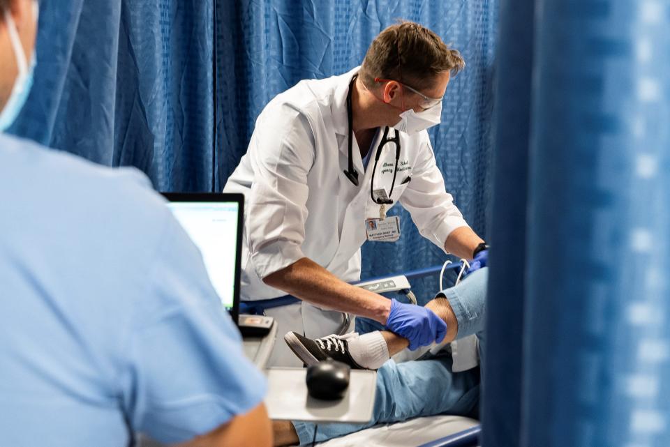 Dr. Matthew Siket tends to a patient in the Emergency Department at the University of Vermont Medical Center.