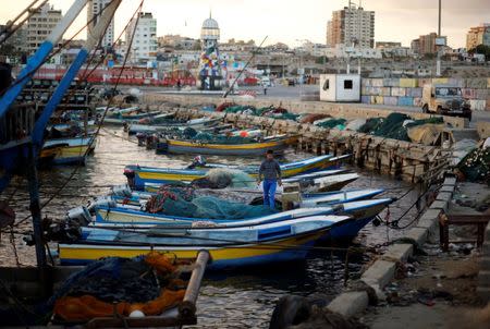 A Palestinian fisherman stands in a boat at the seaport of Gaza City September 26, 2016. REUTERS/Mohammed Salem