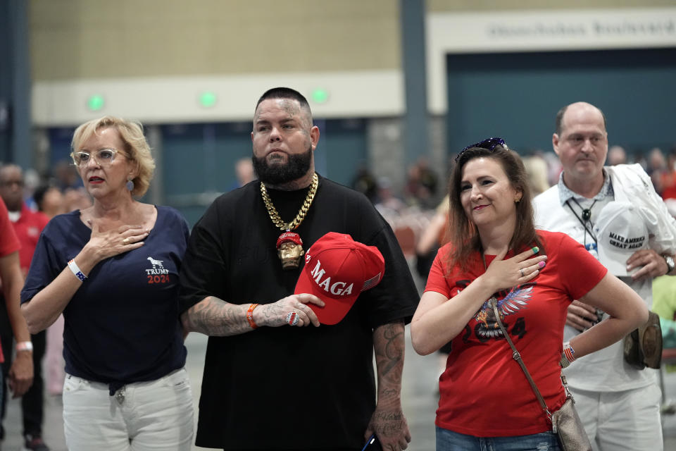 Supporters stand for the National Anthem before Republican presidential candidate former President Donald Trump speaks at his birthday celebration, hosted by Club 47, in West Palm Beach, Fla., Friday, June 14, 2024. (AP Photo/Gerald Herbert)