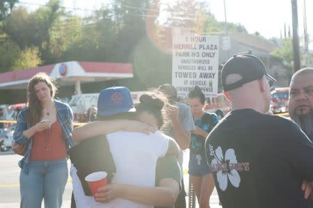 Trader Joe's employees and others wait in a parking lot near a Trader Joe's store where a hostage situation unfolded in Los Angeles, California, July 21, 2018. REUTERS/Andrew Cullen