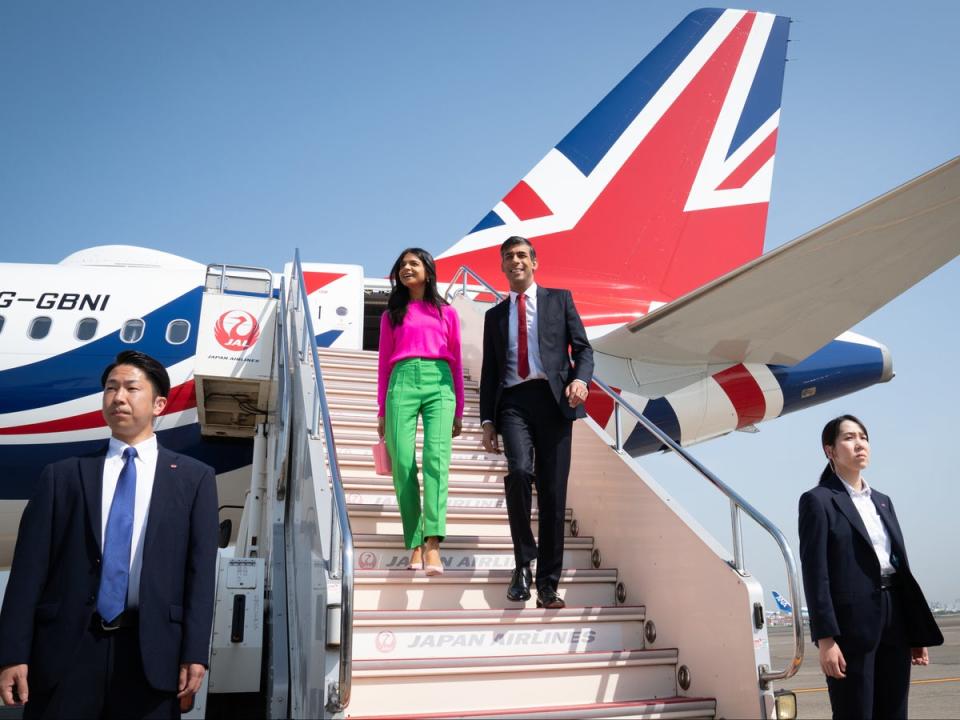 Rishi Sunak and his wife Akshata Murty disembark their plane as they arrive at Tokyo (PA)