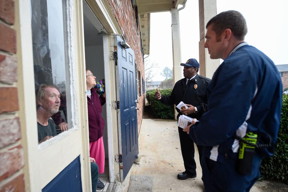 Augusta Fire Department Chief Antonio Burden (center) speaks with residents Rosa Jackson and Tommy Key at Azalea Parks Apartments. Emergency responders handed out information sheets and business cards, as well as answered questions about fire safety, following the Dec. 8 fire. Jackson and Key are neighbors.