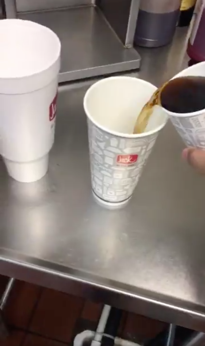 Liquid is poured from the smallest cup into the medium sized one. Photo: Twitter