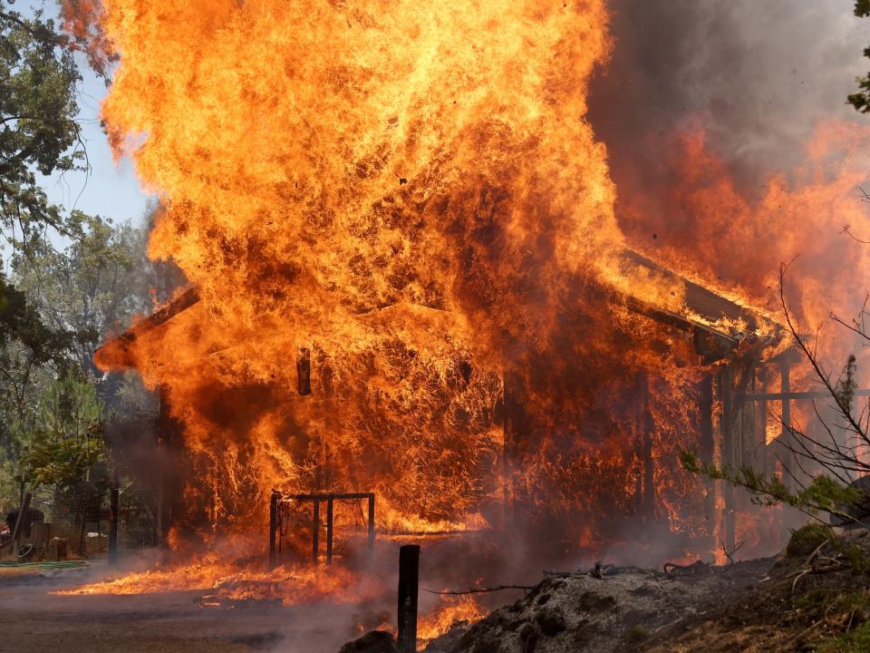 A home burn as the Oak Fire burns through the area on July 23, 2022 near Mariposa, California.