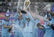 England's captain Eoin Morgan is sprayed with champagne as he raises the trophy (AP Photo/Matt Dunham)