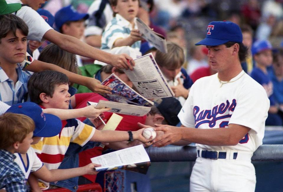 Texas Rangers pitcher Mitch Williams signs autographs before the game with Milwaukee on opening day in 1987 at Arlington Stadium. (Star-Telegram file photo)
