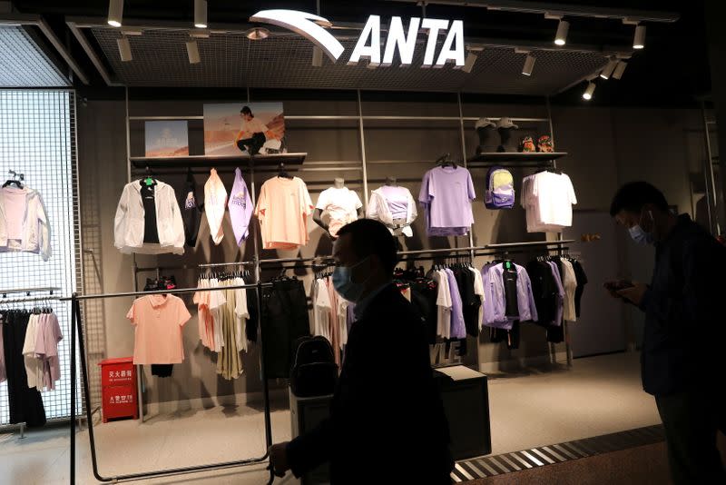 People walk past a store of Chinese sportswear brand Anta in Beijing