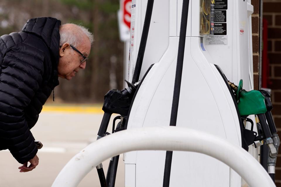 Checking gas prices in Buffalo Grove, Ill., on March 26, 2022.