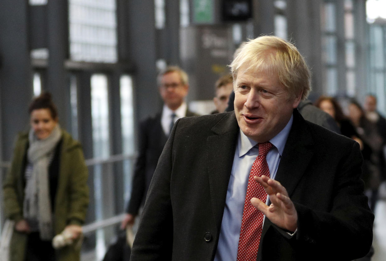 Britain's Prime Minister Boris Johnson arrives on the platform to board a train in London, Friday Dec. 6, 2019, on the campaign trail ahead of the general election on Dec. 12. Johnson pushed for the December vote, which is taking place more than two years early, in hopes of winning a majority and breaking Britain's political impasse over Brexit. (Peter Nicholls/Pool via AP)