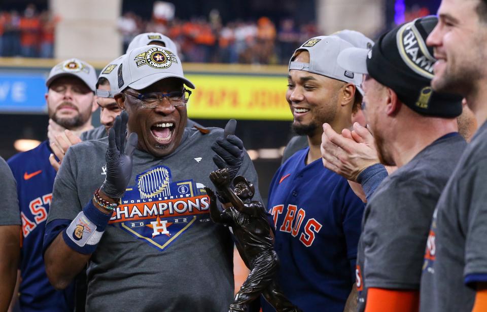 Dusty Baker celebrates on the field after winning the 2022 World Series.