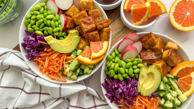 orange tofu rice bowls with colorful vegetables