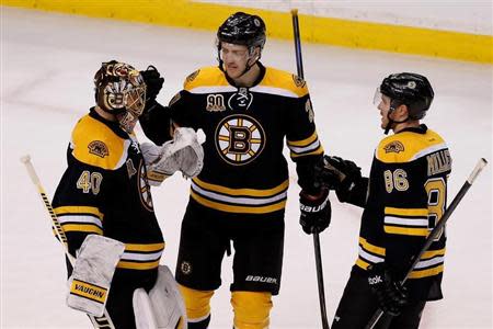 Apr 20, 2014; Boston, MA, USA; Boston Bruins defenseman Dougie Hamilton (27) and defenseman Kevan Miller (86) congratulates Boston Bruins goalie Tuukka Rask (40) after defeating the Detroit Red Wings 4-1 in game two of the first round of the 2014 Stanley Cup Playoffs at TD Banknorth Garden. Greg M. Cooper-USA TODAY Sports