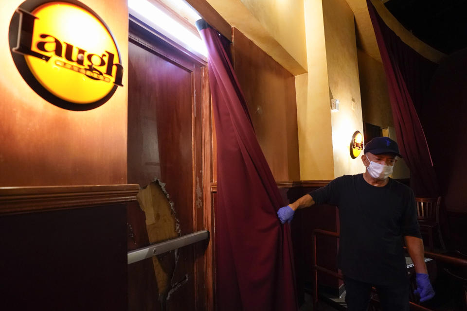 Jamie Masada shows a broken window that has been boarded at Laugh Factory on Monday, June 1, 2020, in Long Beach after overnight protests over the death of George Floyd. Floyd died in police custody on Memorial Day in Minneapolis. (AP Photo/Ashley Landis)