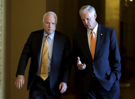 Senators John McCain (R-AZ) (L) and Ron Johnson (R-WI) (R) walk to their weekly party caucus luncheon at the U.S. Capitol in Washington September 16, 2015. REUTERS/Gary Cameron