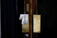 <p>A pair of gloves belonging to a security officer hangs on a door lock near a checkpoint before Indiaís Prime Minister Narendra Modi leaves the United Nations Vesak Day Conference in Colombo, Sri Lanka on May 12, 2017. (Photo: Dinuka Liyanawatte/Reuters) </p>