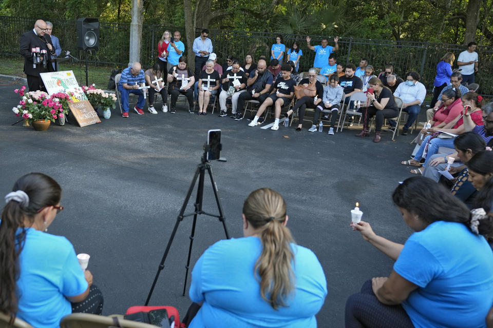 Mourners pray during a memorial vigil at The Farmworkers Association Wednesday, May 15, 2024, in Apopka, Fla. Eight farmworkers from Mexico were killed and dozens more were injured when a pickup truck and bus collided early Tuesday morning in Dunnellon, Fla. (AP Photo/Chris O'Meara)