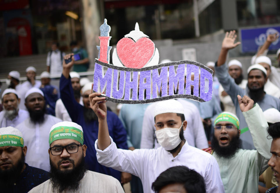 Supporters of Islami Andolan Bangladesh, an Islamist political party, protest against French President Emmanuel Macron and against the publishing of caricatures of the Prophet Muhammad they deem blasphemous, in Dhaka, Bangladesh, Tuesday, Oct. 27, 2020. Muslims in the Middle East and beyond on Monday called for boycotts of French products and for protests over the caricatures, but Macron has vowed his country will not back down from its secular ideals and defense of free speech. (AP Photo/Mahmud Hossain Opu)