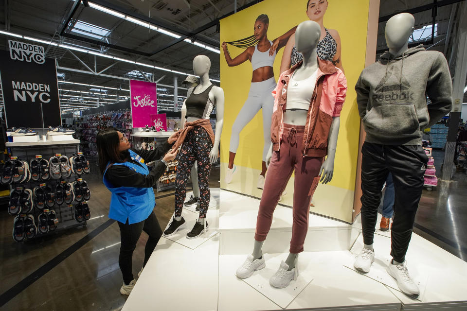 A worker prepares mannequins inside the Walmart Supercenter in North Bergen, N.J., on Thursday, Feb. 9, 2023. Defying high inflation and sharp interest rate hikes, Americans keep spending — a trend that, if sustained, could keep the economy humming just enough to help avoid a much-predicted recession. (AP Photo/Eduardo Munoz Alvarez)