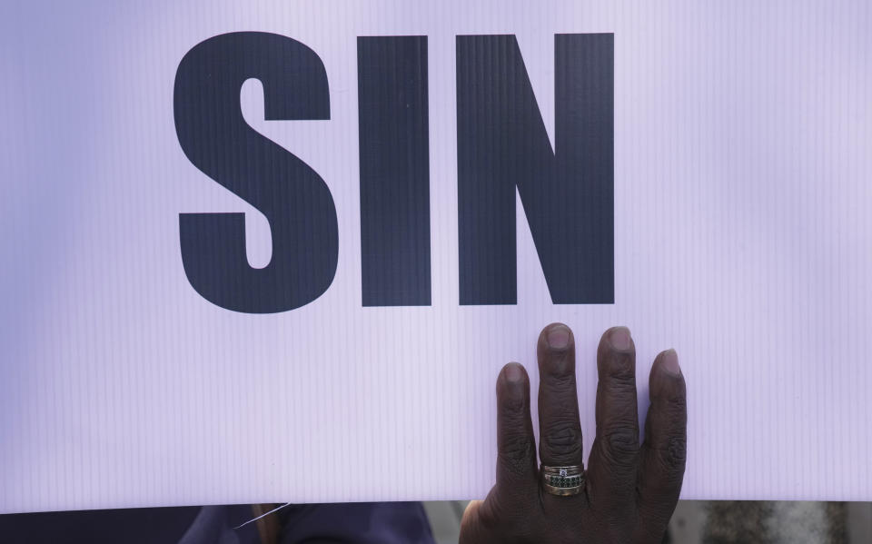 A member of the United Methodist Church in Zimbabwe holds a placard while holding a protest at the church premises in Harare, Thursday, May 30, 2024. The protests denouncing homosexuality and the departure of the church from the scriptures and doctrine, come barely a month after the United Methodist Church Worldwide General Conference held in North Carolina, US repealed their church's longstanding ban on LGBTQ clergy, removing a rule forbidding "self-avowed practising homosexuals" from being ordained or appointed as ministers. (AP Photo/Tsvangirayi Mukwazhi)