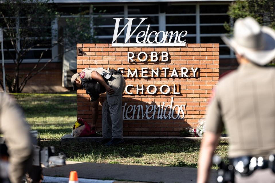 <span class="caption">The latest mass shooting, at Robb Elementary School in Uvalde, Texas, has plunged the country into yet another cycle of collective trauma.</span> <span class="attribution"><a class="link " href="https://www.gettyimages.com/detail/news-photo/texas-state-trooper-receives-flowers-for-the-victims-of-a-news-photo/1240894286?adppopup=true" rel="nofollow noopener" target="_blank" data-ylk="slk:Jordan Vonderhaar/Getty Images News via Getty Images">Jordan Vonderhaar/Getty Images News via Getty Images</a></span>