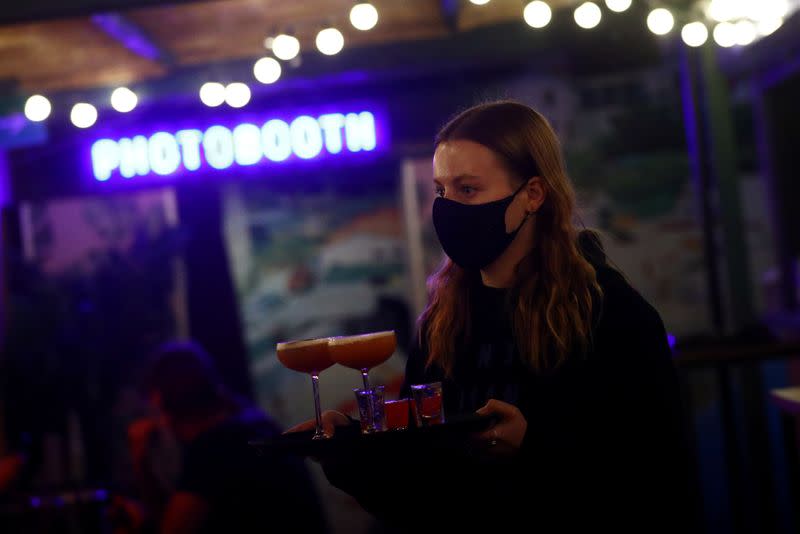 A bartender serves drinks in the Bar Elba in Waterloo, amid the outbreak of the coronavirus disease (COVID-19), in London