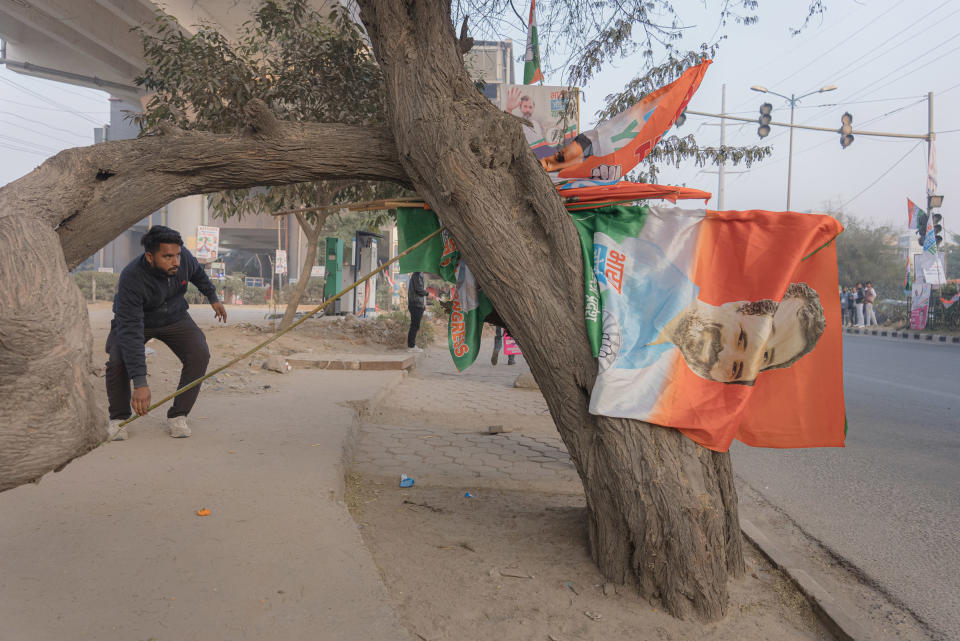 A supporter of the Congress Party gathers flags in New Delhi, India, on Dec. 24, 2022.<span class="copyright">Ronny Sen for TIME</span>