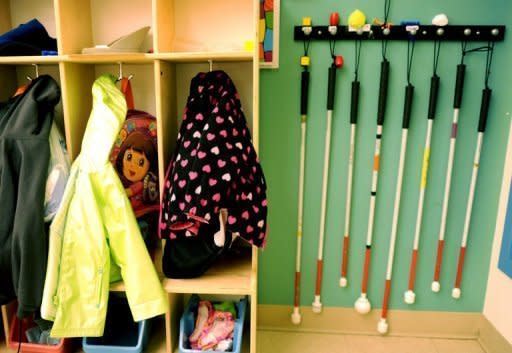 Walking canes hang next to the coat rack at Saint Joseph's School for the Blind in New Jersey. The school helps children with impaired sight see the world in a new way