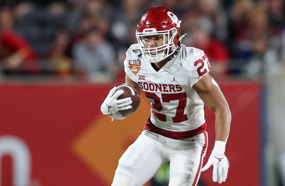 Dec. 29, 2022; Orlando, Florida; Oklahoma Sooners running back Gavin Sawchuk (27) runs with the ball against the Florida State Seminoles in the second quarter during the 2022 Cheez-It Bowl at Camping World Stadium. Nathan Ray Seebeck-USA TODAY Sports