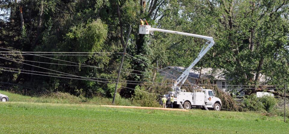 A power truck tackles electric lines that had been pulled down by trees near Shreve.