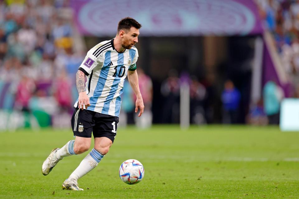 Argentina forward Lionel Messi dribbles the ball against Mexico during the second half of a group stage match during the 2022 World Cup at Lusail Stadium.