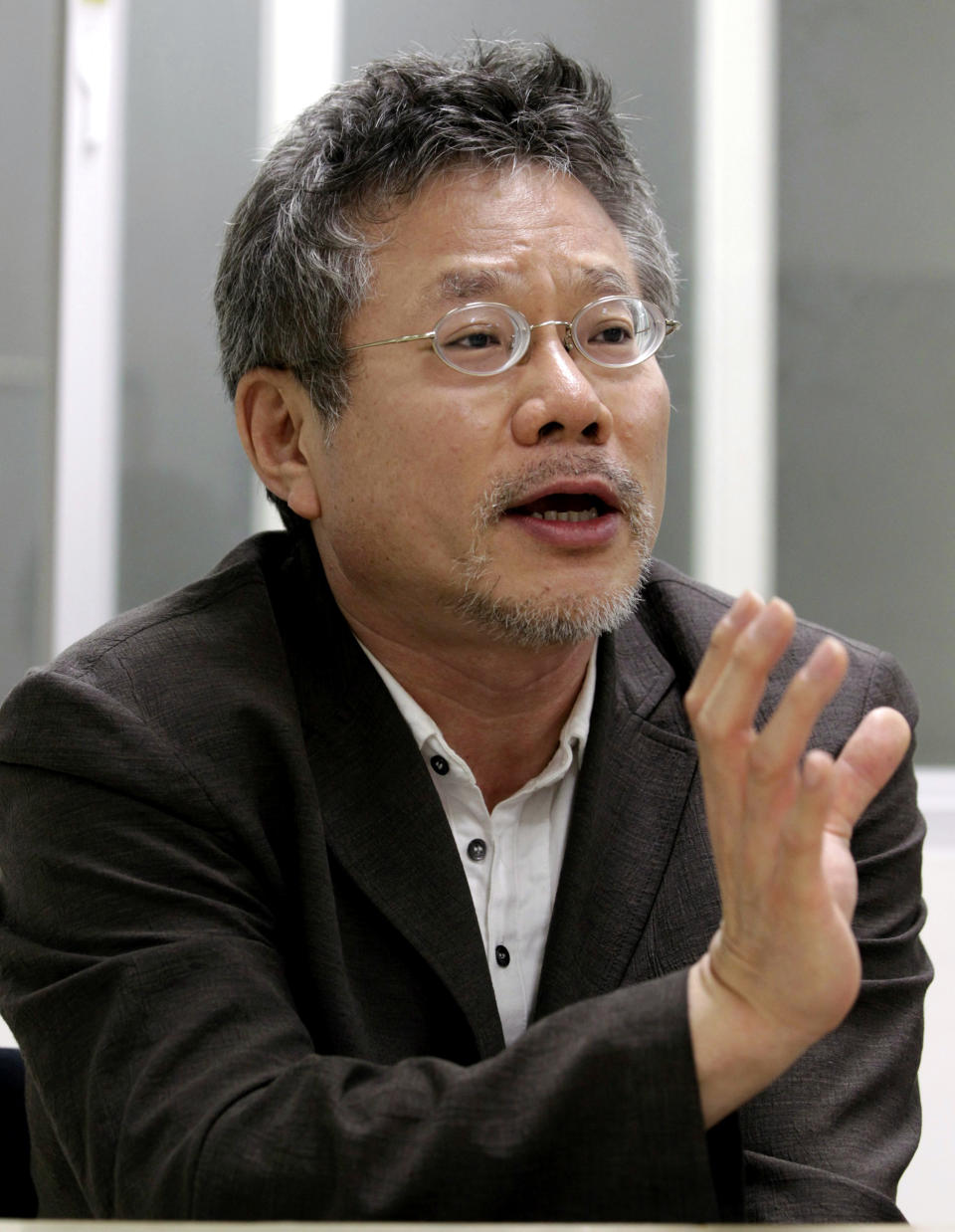 In this July 17, 2012 photo, Choi Yong-bae, Chungeoraham Film CEO and Producer, speaks during an interview with the Associated Press at his office in Seoul, South Korea. After being turned down by many investors over the last four years, Choi said it feels strange and exciting that his revenge film about a notorious South Korean president blamed for the massacre of democracy protesters is finally coming to life through online donations. (AP Photo/Ahn Young-joon)