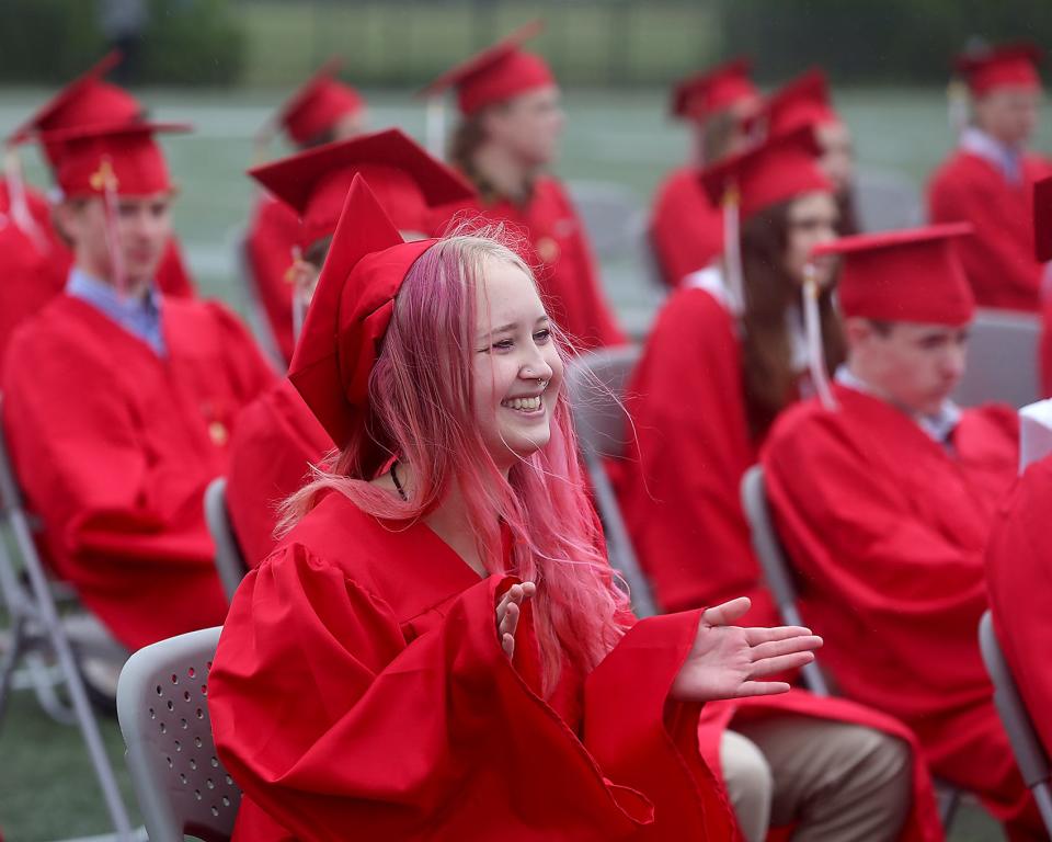 Hingham High senior Lu Martell smiles while cheering on Madelyn McPhillips during Hingham High’s graduation ceremony for the Class of 2023 on Saturday, June 3, 2023. Hingham High graduated 318 seniors. 