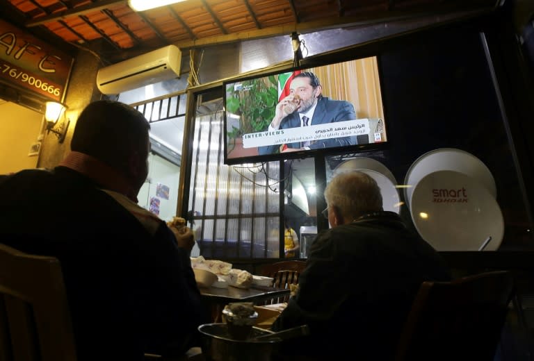 Lebanese watch an interview with resigned prime minister Saad Hariri at a coffee shop in Beirut on November 12, 2017
