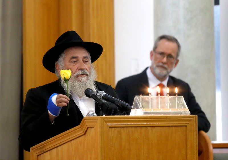 FILE PHOTO: Rabbi Goldstein holds a yellow rose given to his family by Gilbert-Kaye before the synagogue shooting in Poway