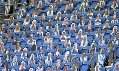 Cutout photos of Brighton fans fill the empty stands during the English Premier League soccer match between Brighton & Hove Albion and Arsenal at the AMEX Stadium in Brighton, England, Saturday, June 20, 2020. (Richard Heathcote/Pool via AP)