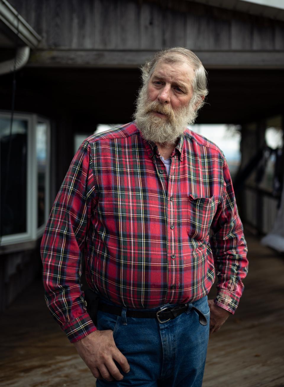 Ben Simons stands out on the back porch of his home with his farmland in the background atop of Starr Hill in Remsen, NY. He was approached by a land agent interested in leasing acres of Simons’ land to build an array of solar panels to convert the sun’s energy into electricity and deliver it to the state’s electrical grid.