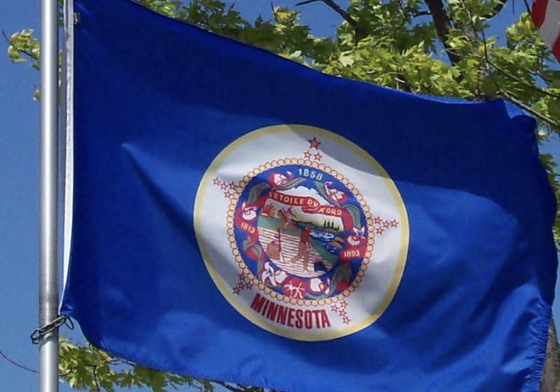 Minnesota's current flag has been criticized for decades for being offensive toward Native Americans. The emblem in the middle, which is considered too busy to decipher from a distance, depicts a Native American riding into the sunset as a White settler plows a field. Photo courtesy of Minnesota Secretary of State