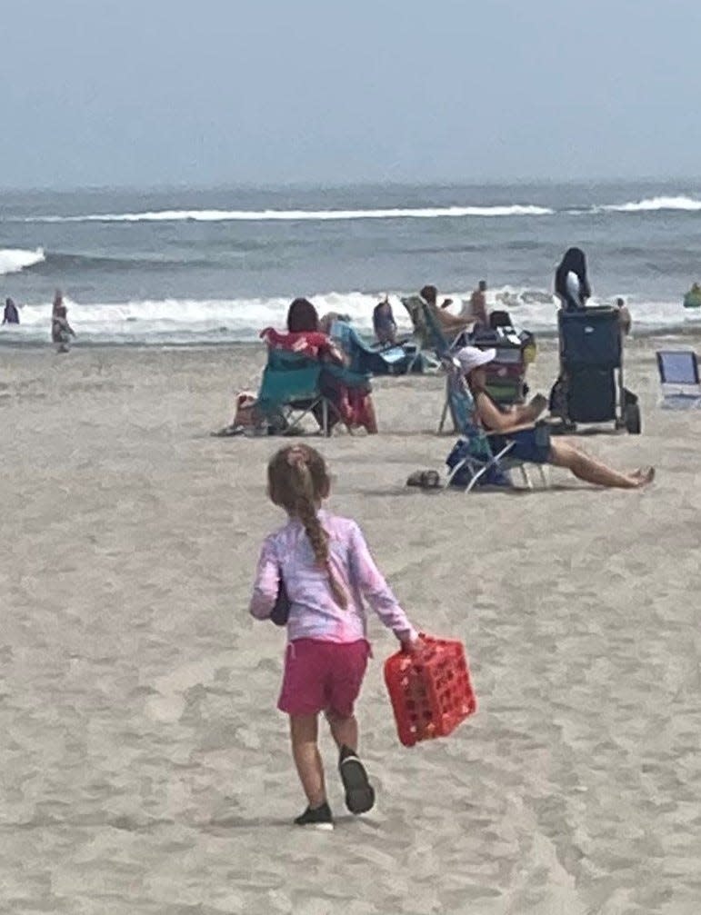 A girl arrives prepared for fun during a recent visit to the beach at Atlantic City, The National Weather Service is warning of an elevated risk of rip tides due to Hurricane Franklin.