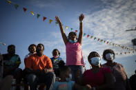 Ka'miyah Buck, 9, cheers while watching a pig race at the Mississippi State Fair, Wednesday, Oct. 7, 2020, in Jackson, Miss. The virus ripped through Mississippi's Black community early in the pandemic. About 60% of infections and deaths were among African Americans, who make up 38% of the state's population. (AP Photo/Wong Maye-E)