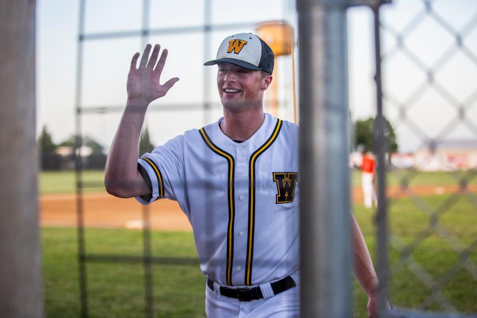 Winterset pitcher Justin Hackett gets a high five from a teammate during Tuesday game against Carroll at Winterset High School.