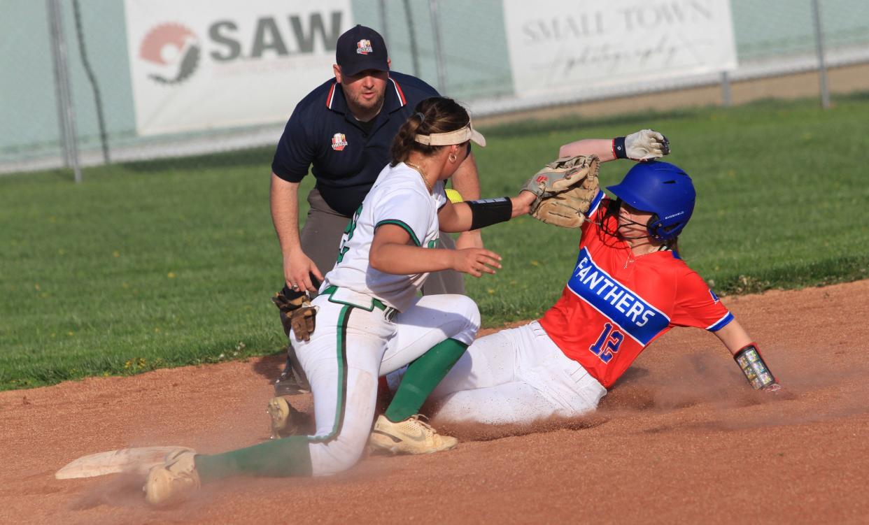 Licking Valley's Hailey Small slides safely into second base as the ball skips past Newark Catholic's Kami Diaz on Tuesday.