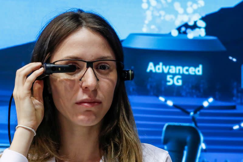 FILE PHOTO: A visitor tries out a VR headset at the Telefonica booth during the Mobile World Congress in Barcelona