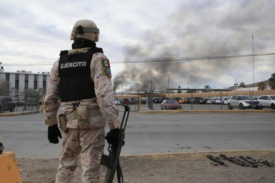 A Mexican solider stands guard at a prison in Ciudad Juarez after dozens of inmates escaped on 1 January (Associated Press)