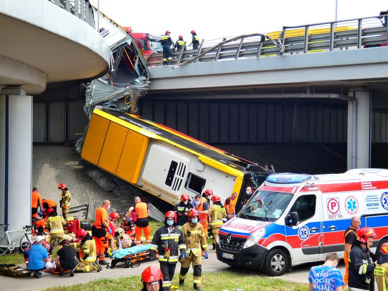 First responders attend to the scene of a public bus crash in Warsaw