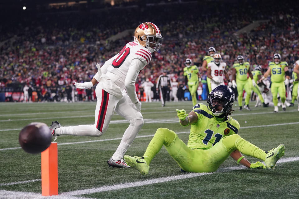 San Francisco 49ers cornerback Ambry Thomas (20) breaks up a pass intended for Seattle Seahawks wide receiver Jaxon Smith-Njigba (11) during the second half of an NFL football game, Thursday, Nov. 23, 2023, in Seattle. (AP Photo/Lindsey Wasson)
