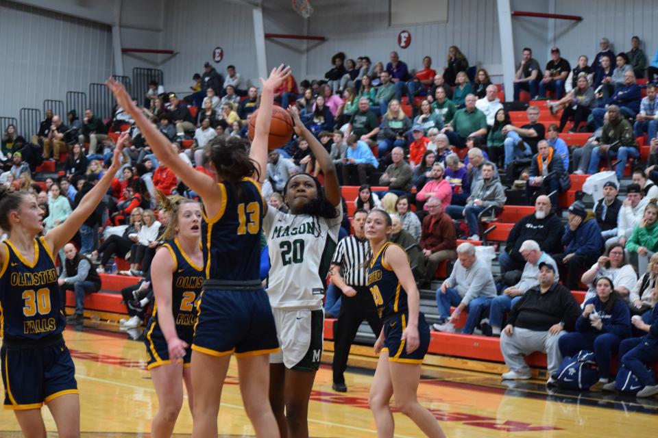 Mason's Madison {Parrish drives to the hole against Olmsted Falls defender Erin Bich.