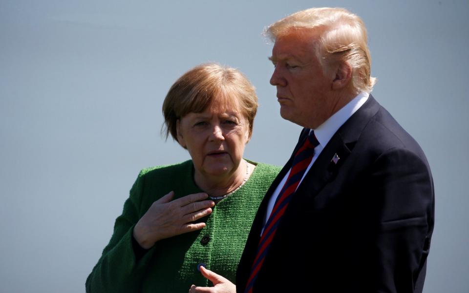 Germany's Chancellor Angela Merkel talks with US President Donald Trump. The President was fiercely critical of German's energy ties with Russia during a recent Nato conference - REUTERS