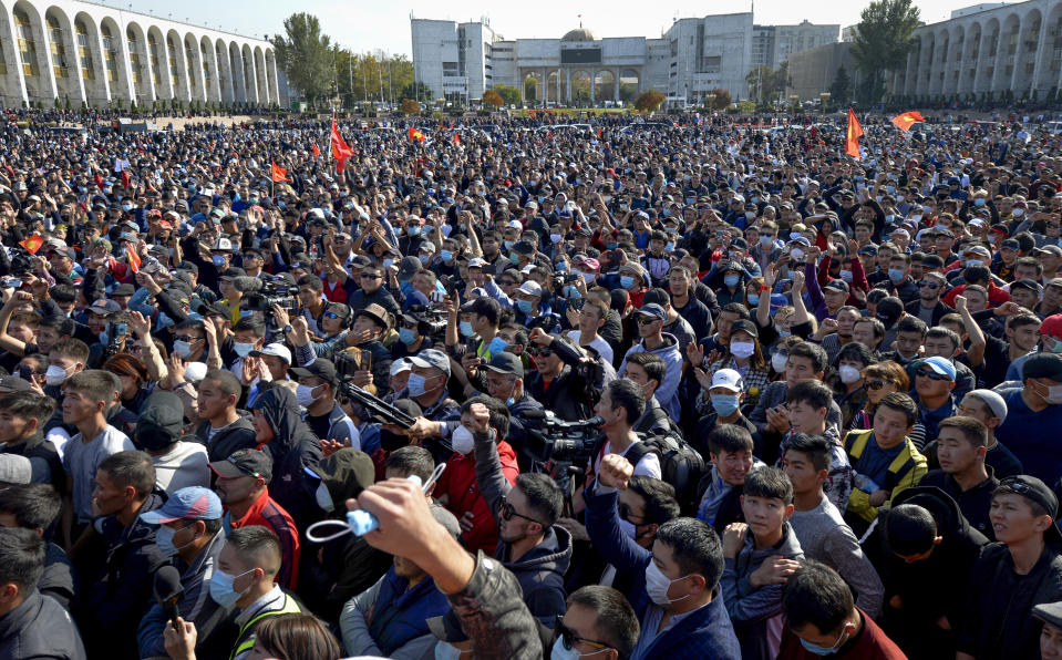 People protest during a rally against the results of a parliamentary vote in Bishkek, Kyrgyzstan, Monday, Oct. 5, 2020. Large crowds of people have gathered in the center of Kyrgyzstan's capital to protest against the results of a parliamentary election, early results of which gave the majority of seats to two parties with ties to the ruling elites amid allegations of vote buying. (AP Photo/Vladimir Voronin)