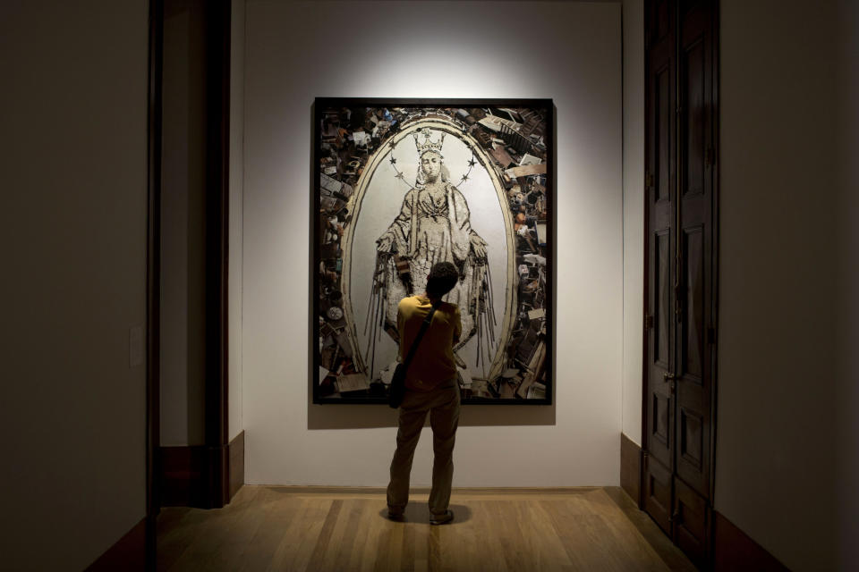 A man looks at a photograph by Vik Muniz, titled 'Nossa Senhora das Gracas' at the Casa Daros museum in Rio de Janeiro, Brazil, Wednesday, March 20, 2013. Local officials aiming to transform Rio de Janeiro from a sleepy cultural backwater into an art hotspot are inaugurating this week Casa Daros, a new museum that draws on one of the world's premier collections of contemporary Latin American art. Casa Daros, a 12,000-square meter (129,000-square foot) exhibition space housed in a renovated 1866 mansion, will bring to Rio some of the around 1,200 pieces acquired over the past 13 years by independently wealthy Zurich-based collector Ruth Schmidheiny. (AP Photo/Felipe Dana)