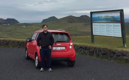 Wally Nowinski poses with a car in Iceland in this 2016 handout photo provided May 25, 2017. Courtesy Anne VanderMey/Handout via REUTERS